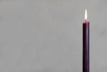 Lit purple candle